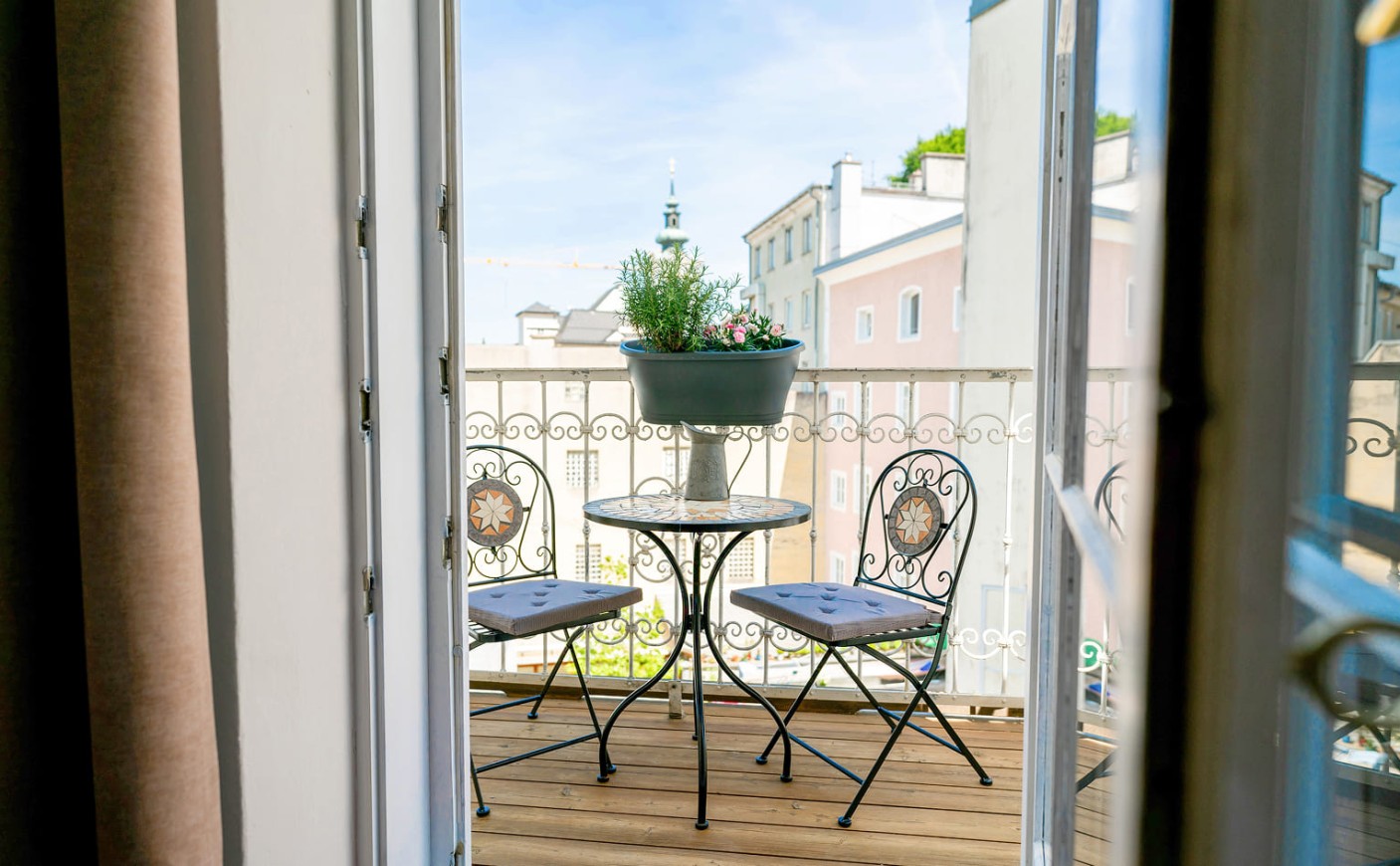 Balkon mit Sitzgelegenheit und Blick auf die Stadt